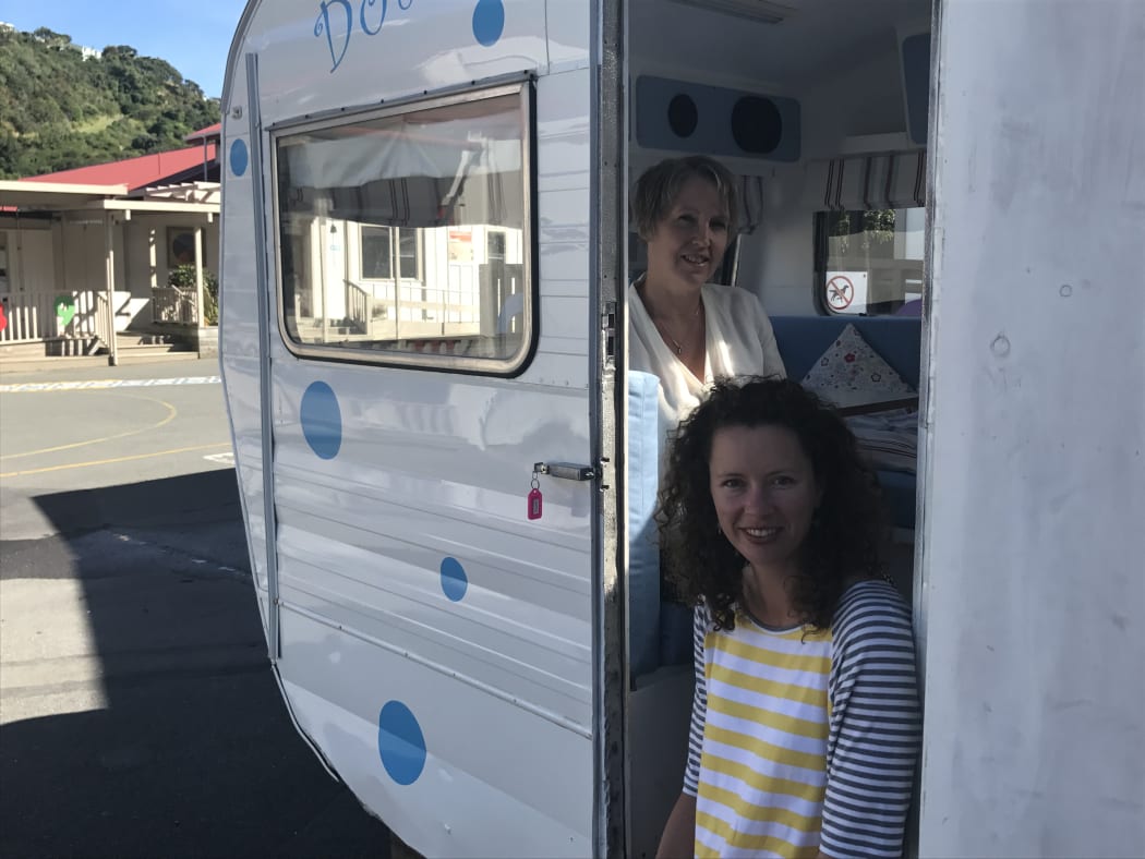 Houghton Valley principal Raewyn Watson and board chairperson Sarah Graydon with “Dotty,” the caravan the school is using for small-group work.