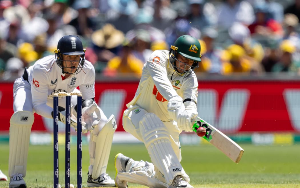 ADELAIDE, AUSTRALIA - DECEMBER 17: Usman Khawaja of Australia plays a sweep shot during day one of the Third Test Match in the 2025/26 Ashes Series between Australia and England at Adelaide Oval on December 17, 2025 in Adelaide, Australia. (Photo by Santanu Banik/MB Media/Getty Images)