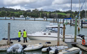 Maritime NZ officials at Port Opua boatyard assess the motorboat that crashed into a ferry in the Bay of Islands on Thursday.