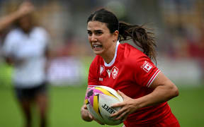 Canada's full back Julia Schell runs to score her fifth try during the Women’s Rugby World Cup pool B match between Canada and Fiji at York Community Stadium in York, northern England, on August 23, 2025. (Photo by Paul ELLIS / AFP)