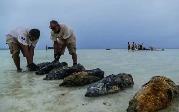 The team from CGD collects 70-year-old 200mm projectiles from the wreckage of a barge in Peleliu, Palau.