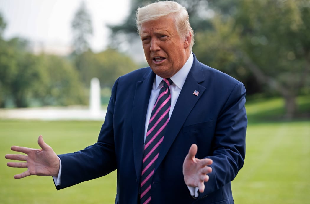 US President Donald Trump speaks to the press as he departs from the South Lawn the White House on 18 September.