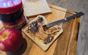 A Marmite sandwich being made.