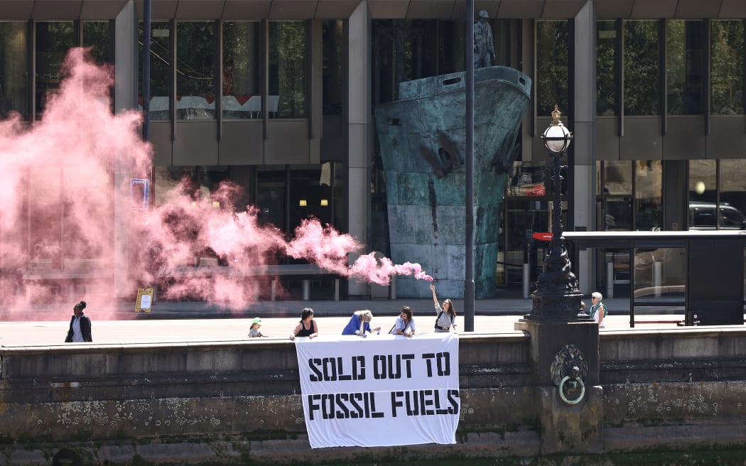 Activists from the Ocean Rebellion group protest outside the International Maritime Organization (IMO) at the end of the 80th Marine Protection Committee (MEPC) conference in London on July 7, 2023. The International Maritime Organization, overseer of the highly-polluting shipping industry, sealed a landmark deal Friday to improve its target to cut carbon emissions but green campaigners said it fell far short. (Photo by HENRY NICHOLLS / AFP)