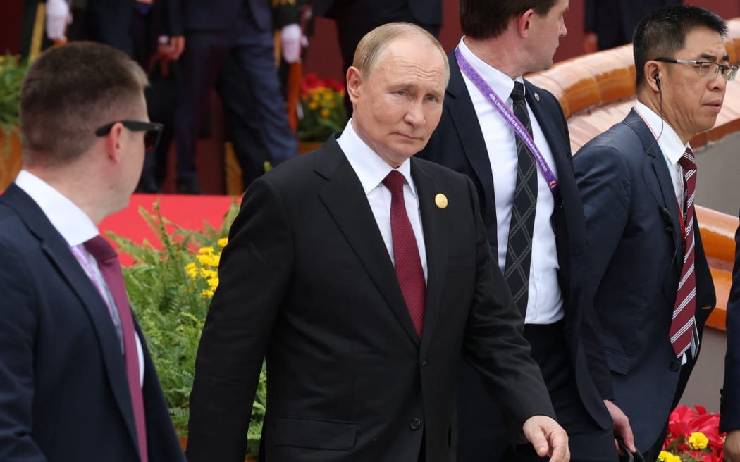 In this pool photograph distributed by the Russian state agency Sputnik, Russia's President Vladimir Putin (C) walks after taking a group photograph during a military parade marking the 80th anniversary of victory over Japan and the end of World War II, in Beijing’s Tiananmen Square on 3 September, 2025.