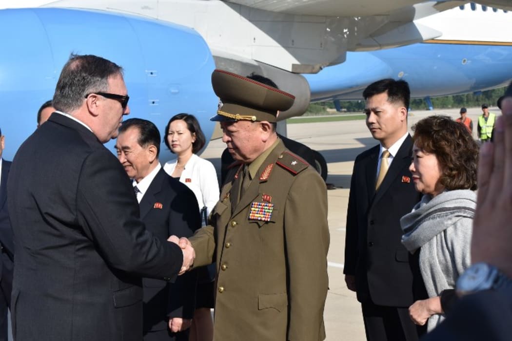US Secretary of State Mike Pompeo greets an unidentified North Korean general on arrival at the Pyonyang, North Korea airport on May 9, 2018.