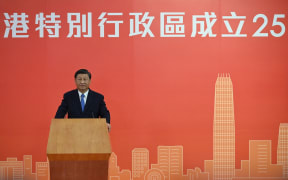 China's President Xi Jinping speaks following his arrival via high-speed rail across the border in Hong Kong on June 30, 2022, for celebrations marking the 25th anniversary of the city's handover from Britain to China.