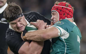 All Black Scott Barrett is tackled by Josh van der Flier of Ireland.