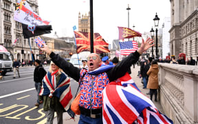Brexit supporters carry flags and placards as they walk down Whitehall in central London.