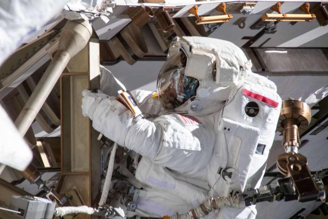 Astronaut Anne McClain working on the International Space Station's Port-4 truss structure during a six-hour, 39-minute spacewalk to upgrade the orbital complex's power storage capacity.