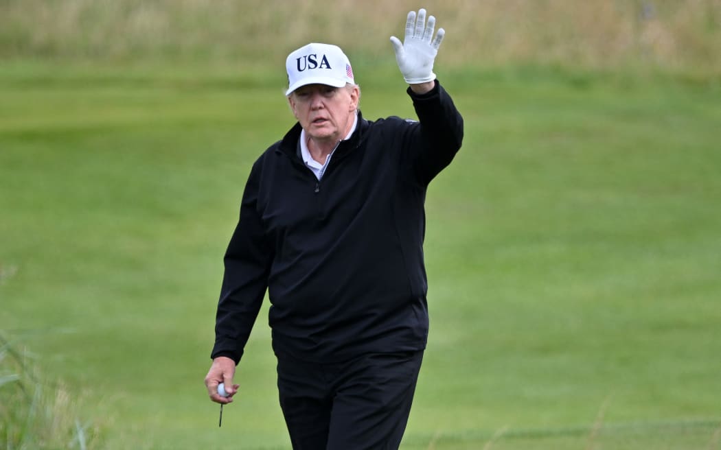 US President Donald Trump reacts as he plays golf at the Trump Turnberry Golf Courses, in Turnberry on the south west coast of Scotland on July 26, 2025, during the second day of his visit to the country, since his second tenure as President began. The Presidents visit to Scotland's picturesque Turnberry underlines the US president's long-held desire to host golf's illustrious British Open at the famous course, despite numerous stumbling blocks. (Photo by ANDY BUCHANAN / AFP)