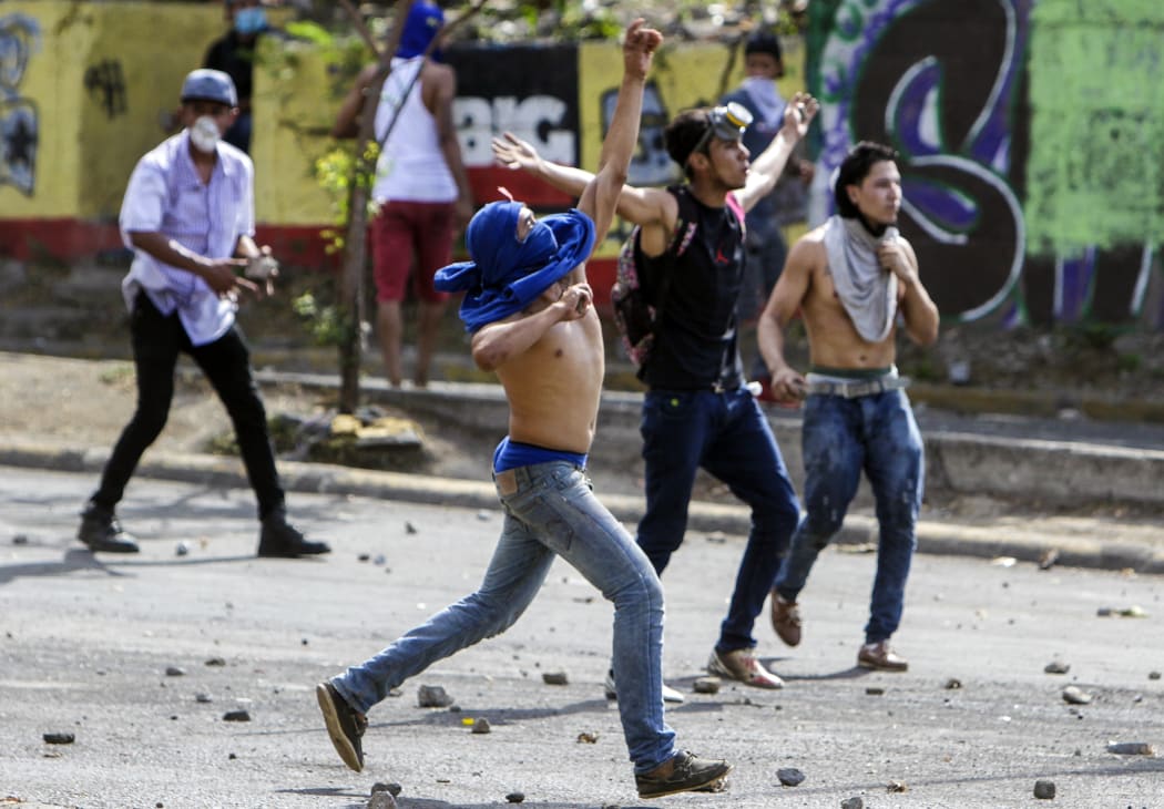 Students clash with riot police agents close to Nicaragua's Technical College during protests against government's reforms in the Institute of Social Security (INSS) in Managua on April 21, 2018.