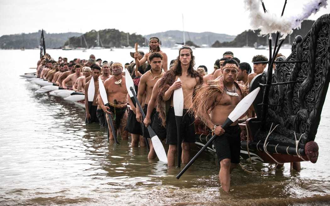 Kaihoe stand ready as Ngatokimatawhaorua beaches outside Te Tii Waitangi Marae on Waitangi Day 2020, the 80th Anniversary of its launch.