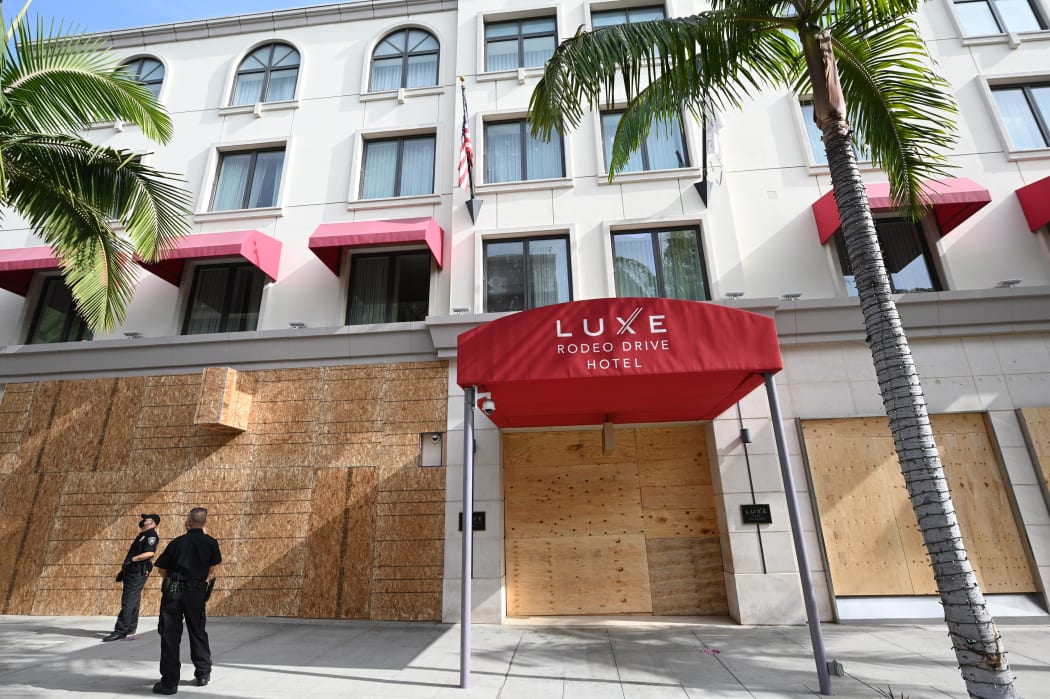 Stores on Rodeo Drive, the world renowned shopping street in Beverly Hills, California, are boarded up and closed to vehicular and pedestrian traffic on November 3, 2020