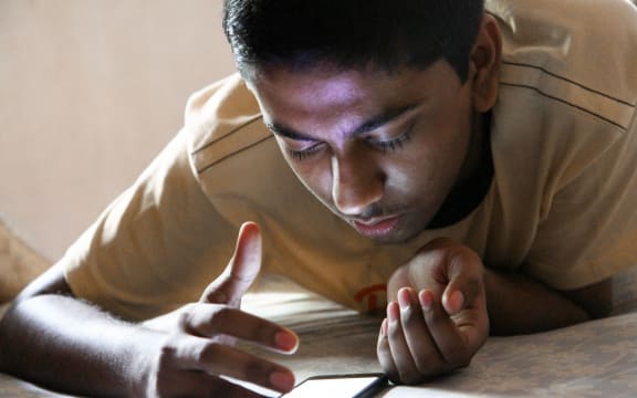 Teen boy in yellow shirt