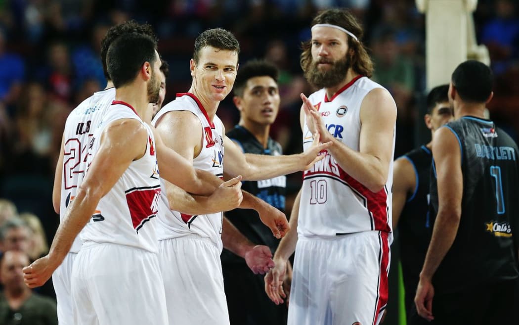 Kirk Penney celebrates with his Hawks team-mates. Photo: Anthony Au-Yeung / www.photosport.nz