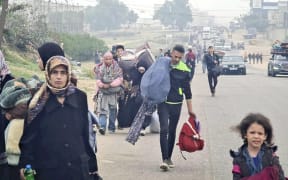 People fleeing from Khan Younis to Rafah, the southern city in the Gaza Strip on 5 December, 2023, after Israeli military attacks resumed.