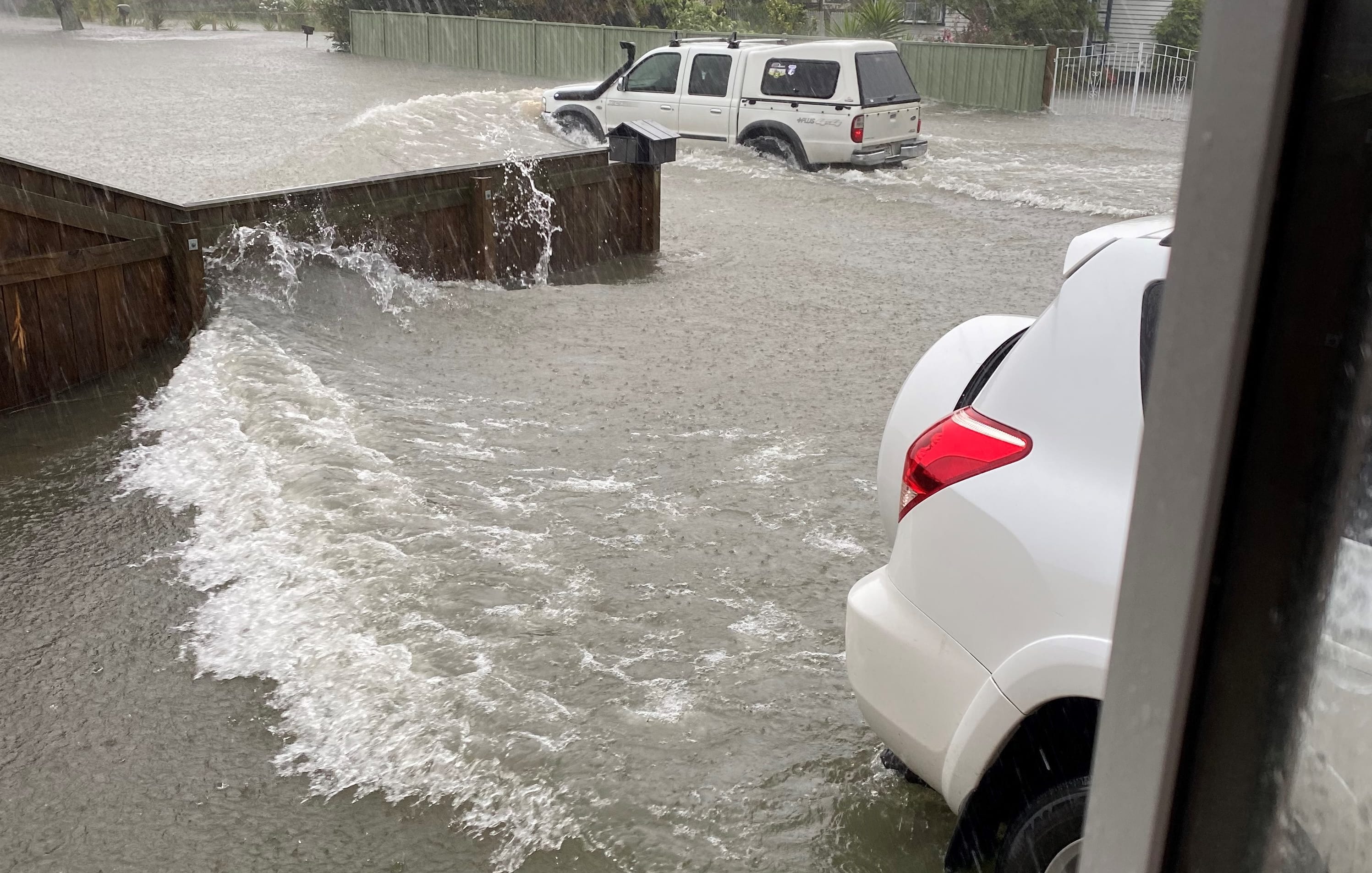 Waves of water hit Tracey Tasovac’s front yard on the day of the floods last year