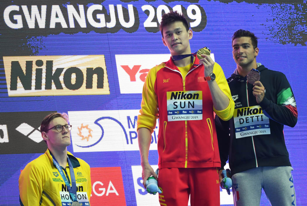 Silver medallist Australia's Mack Horton (left) refuses to stand on the podium with gold medallist China's Sun Yang (centre) and bronze medallist Italy's Gabriele Detti after the final of the men's 400m freestyle at the 2019 World Championships in South Korea.