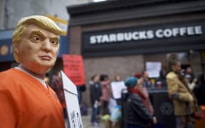 A protester demonstrates outside a Center City Starbucks after Philadelphia Police arrested two black men in the same Center City Starbucks.