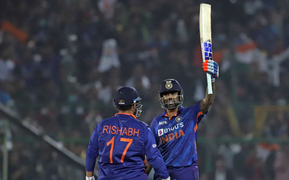 Suryakumar Yadav of India raises his bat after scoring fifty.