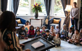 Children listening to Dame Cindy Kiro