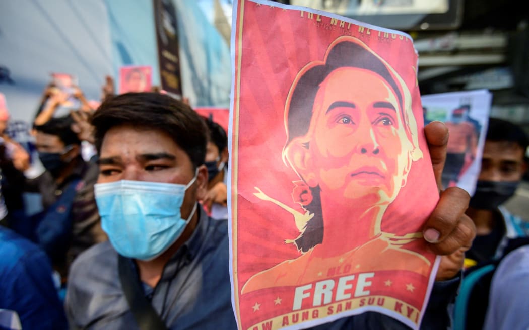 A protester holds a photo of detained Myanmar civilian leader Aung San Suu Kyi during a demonstration against the military coup.