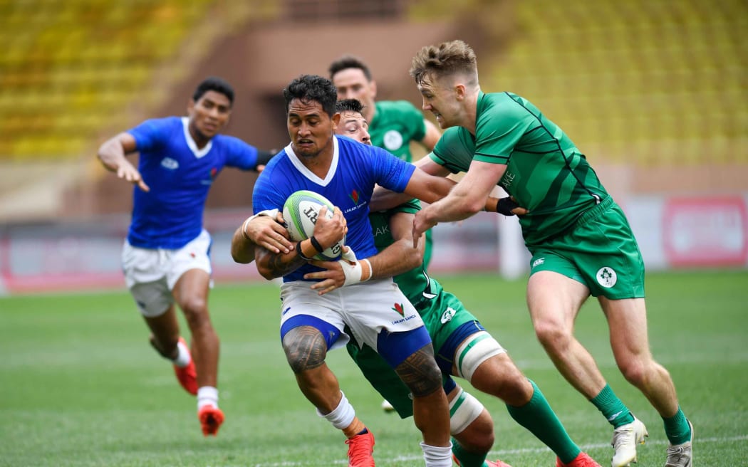 Samoa captain Melani Matavao is brought down by the Irish defence.