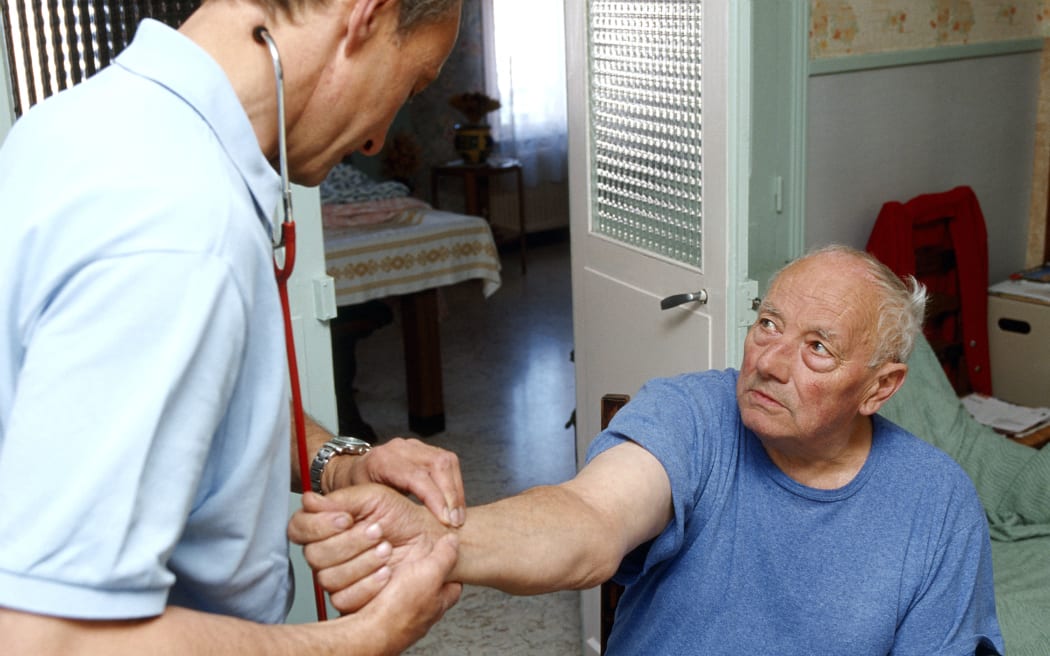 A doctor carries out an examination of a patient.