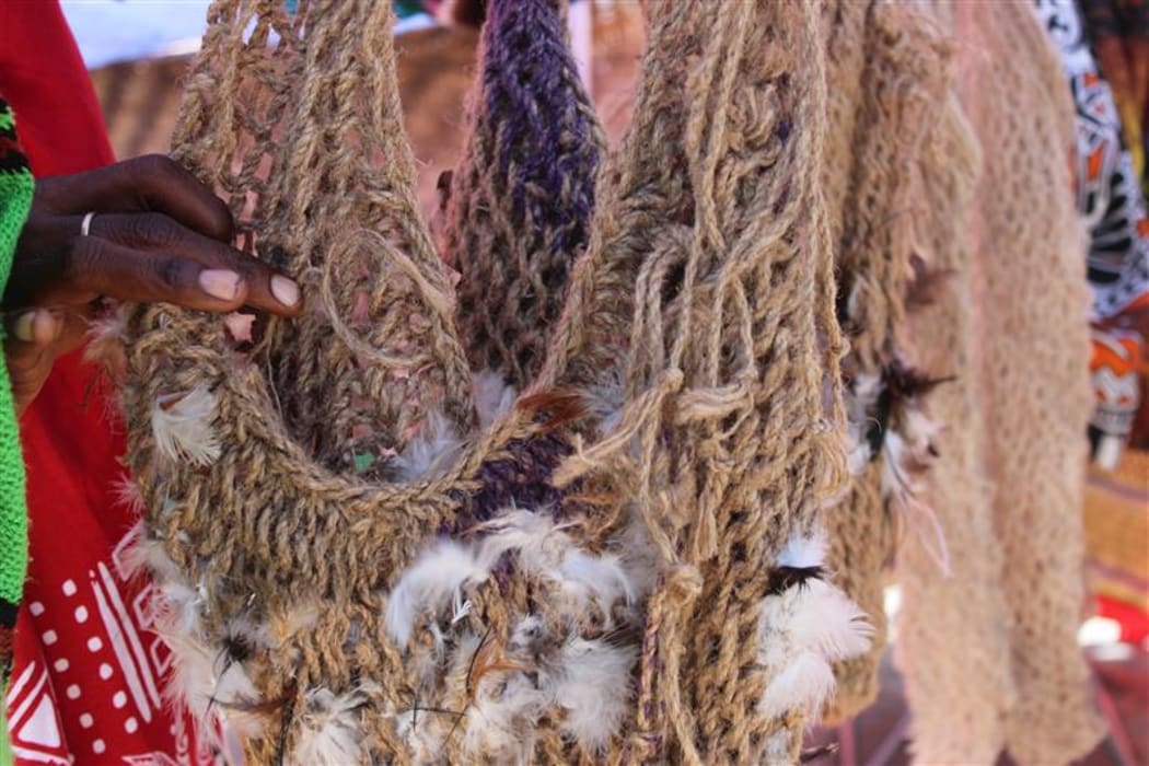 Chicken feathers woven into plant fire bium from Boana, Morobe Province. Bilum making is as diverse as the languages of PNG.