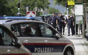 Police walk near a school where several people died in a shooting, on June 10, 2025 in Graz, southeastern Austria. Ten people died after a suspected shooter opened fire in a southeastern Austrian school, press agency APA quoted Graz city mayor Elke Kahr as saying. Several students and at least one adult are among those killed, Kahr confirmed to APA. (Photo by Alex HALADA / AFP)