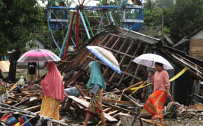 Residents search through debris in Tanjung Lesung, Banten province on December 24.