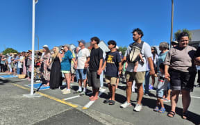 About 250 people formed a human chain outside Napier Health to protest cuts to urgent after-hours services.