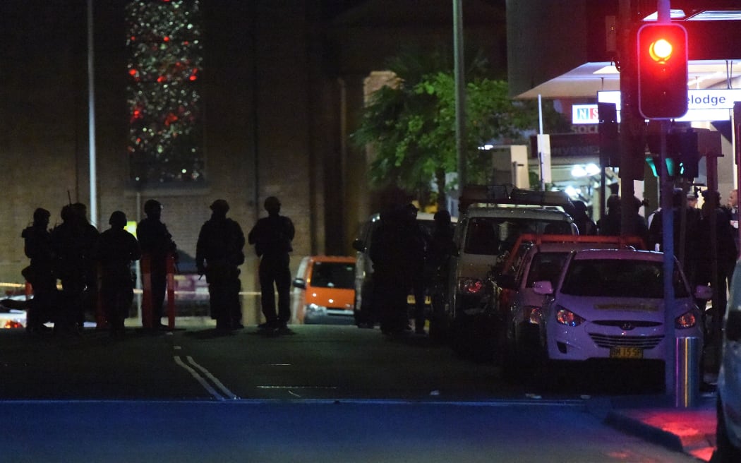 Armed police outside the cafe where a gunman took people captive in central Sydney.