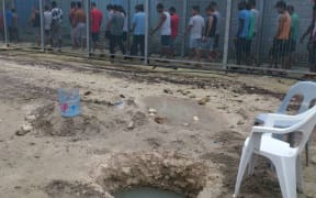 Manus Island refugees and one of their wells.