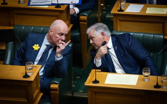 Mark Mitchell appears to brief Christopher Luxon on the name suppression order that Rawiri Waititi has alluded to during a question that ACT's David Seymour has taken issue with.