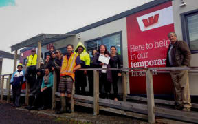 Ruatoria residents with a petition signed by hundreds of people demanding the only bank in town stays open. Their campaign has the support of Gisborne District Councillor Bill Burdett (far right).