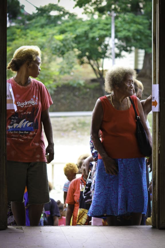 Voters line up outside a polling station in Honiara during the 2014 National General Election.