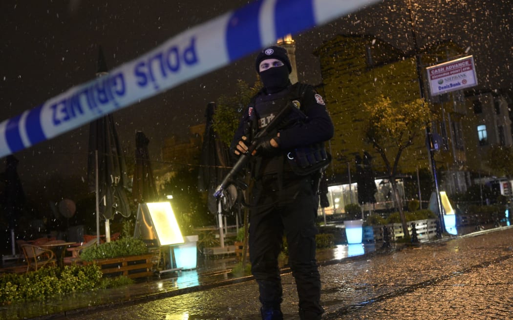 A police officer stands guard along a street after a female suicide bomber was killed in Istanbul.