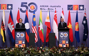 Laos' Prime Minister Sonexay Siphandone (L) and Australia's Prime Minister Anthony Albanese (R) deliver the final statement after the 50th ASEAN-Australia Special Summit in Melbourne on 6 March, 2024.