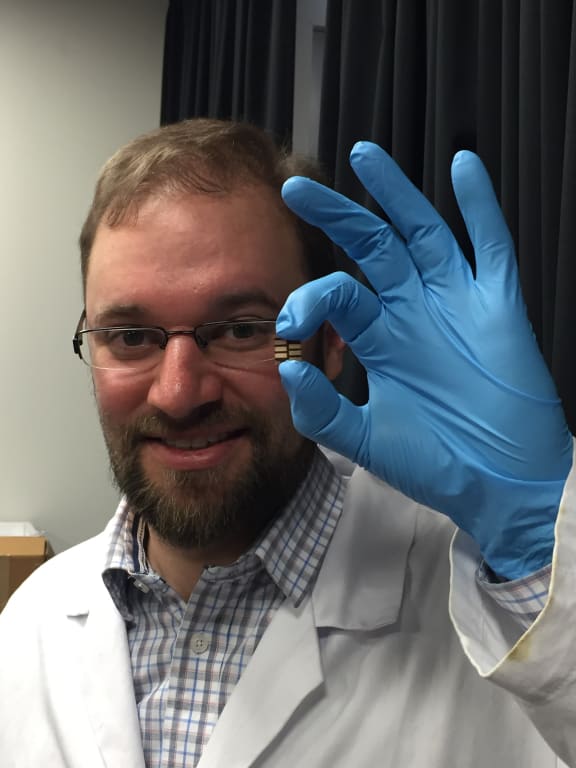 Jonathan Halpert with a solar cell based on perovskites.