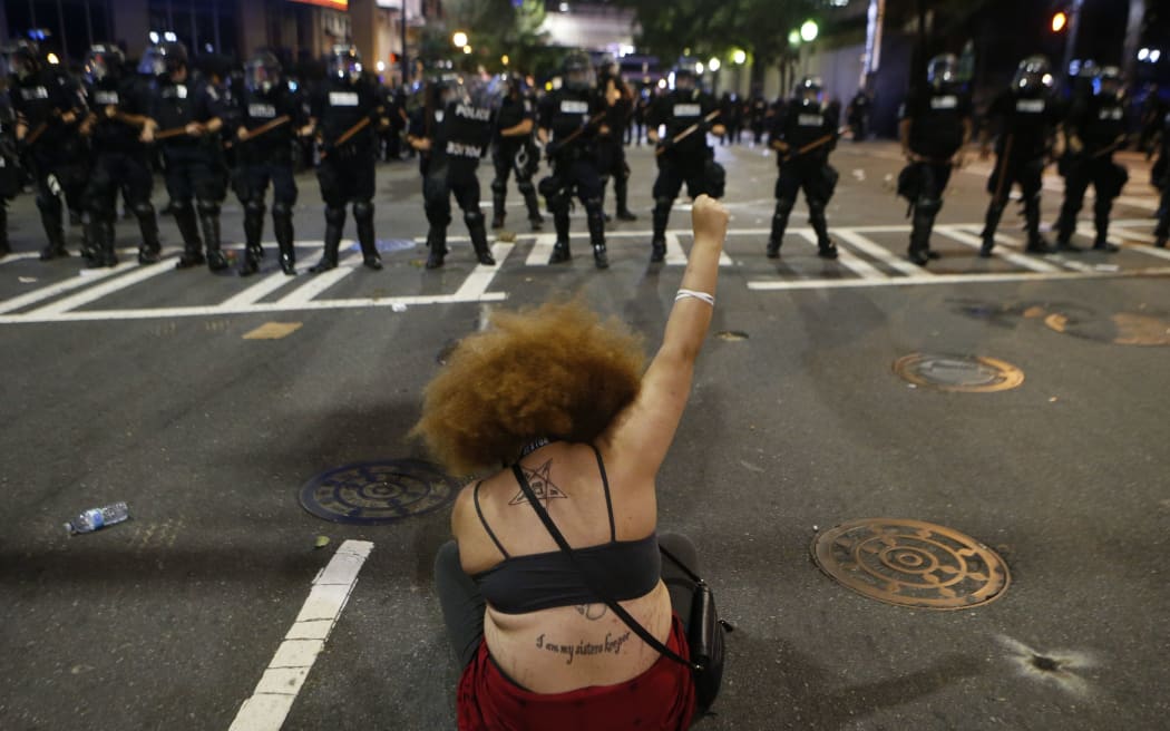 Police clash with protestors as residents and activists protest the death of Keith Scott September 21, 2016 in Charlotte, North Carolina.
