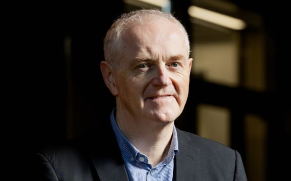 A mid-shot of a man in a suit.