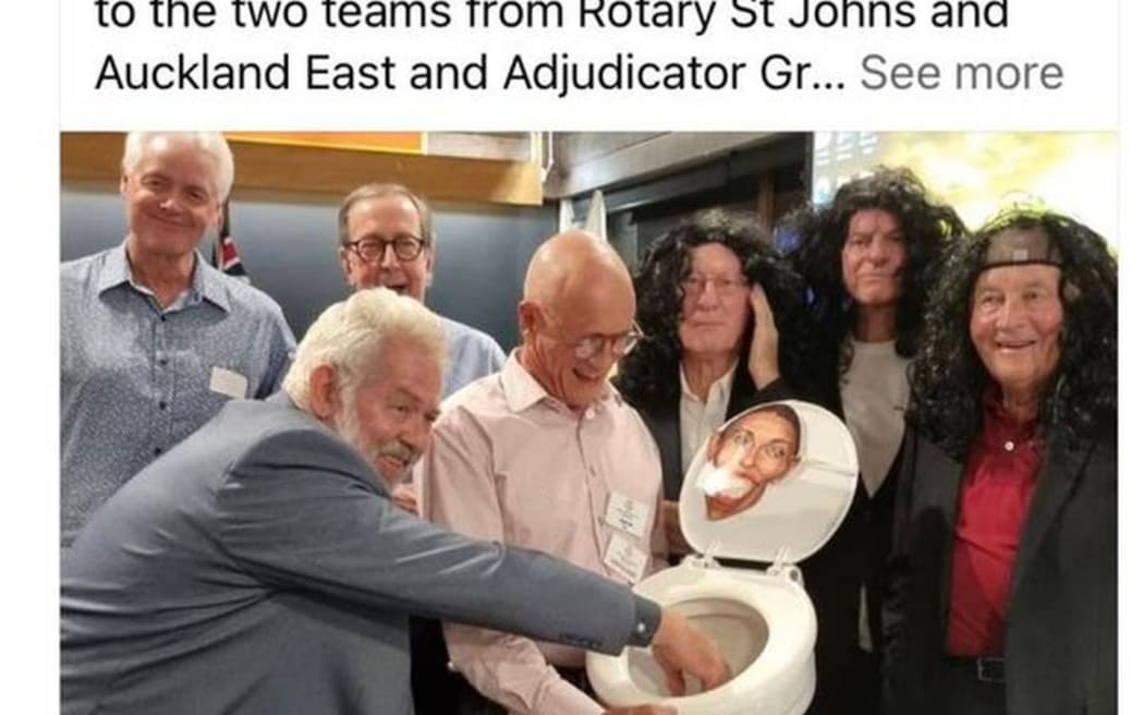 A screenshot of the now-deleted post taken by the New Zealand Herald shows a group of men surrounding the toilet seat with a caricature of former Prime Minister Jacinda Ardern seemingly stuck to the lid.