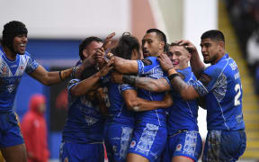 Samoa players celebrate their second try during the 2021 rugby league World Cup quarter-final against Tonga