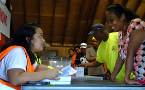 Election official Lisa Lajkam verifies Uliga ward voters in the first minutes after the voting station at the Youth to Youth in Health community center opened Monday morning. Majuro 18 November 2019
