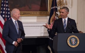Former US Vice President Joe Biden wipes away tears as he walks past former president Barack Obama after he was awarded the Presidential Medal of Freedom during a tribute to Biden at the White House in Washington, DC on January 12, 2017.