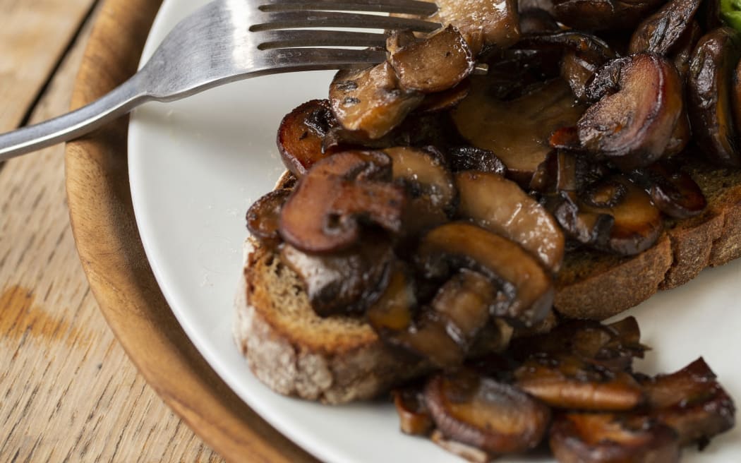 [United Kingdom] High angle close up of Chestnut mushrooms and avocado on toasted sourdough bread on a plate. (Photo by Mint Images / Mint Images / Mint Images via AFP)