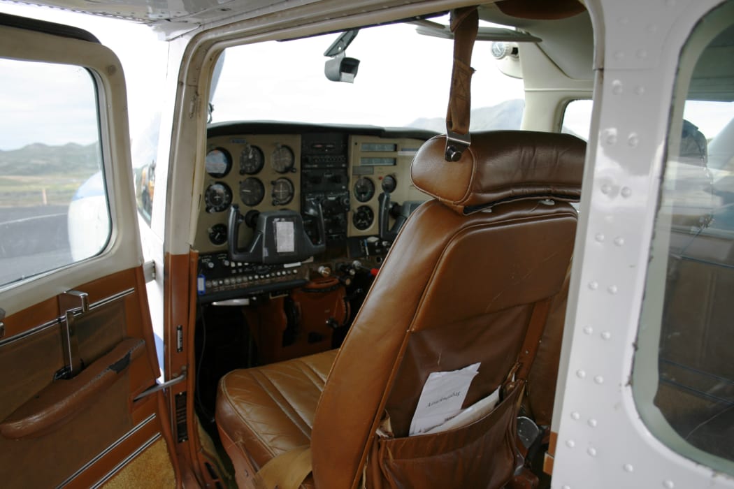 small cesna airplane with open door. Looking into interior and instruments. Instruments out of focus.