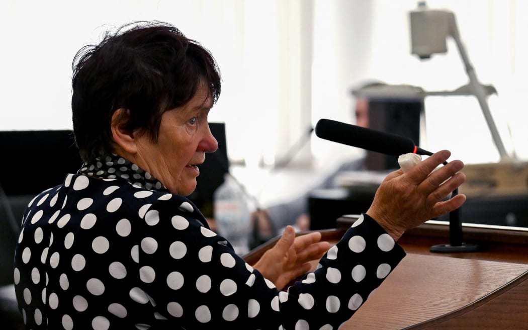 Kateryna Shelipova gestures as she testifies about the death of her husband Oleksandr  against captive Russian soldier, Vadim Shishimarin (unseen) during the second day of his trial on war crimes for killing a civilian, at a courthouse in Kyiv on May 19, 2022.